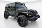 Green 2009 Jeep Wrangler in professional white studio
