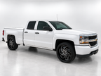 White Chevrolet Silverado with professionally edited studio background